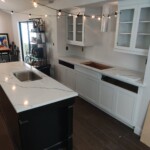 Modern kitchen with white cabinets and island.