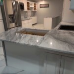 New marble countertop installed with a cutout for a sink in a kitchen.