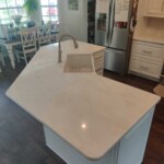Modern kitchen island with a built-in sink and faucet.
