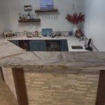 Cozy kitchen with modern appliances and a stone countertop.
