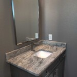 Modern bathroom vanity with marble countertop and undermount sink.