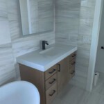 Modern bathroom with wood and white finishes.