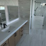 Modern bathroom with sleek design and glass shower enclosure.