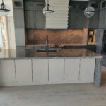 Modern kitchen with a large island and pendant lights.