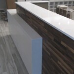 Modern reception desk with white and wood finish in an office.
