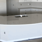 Modern kitchen island with a sleek marble countertop and built-in sink.